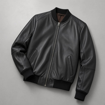 Men's Black Leather Bomber Jacket, flat lay on grey concrete