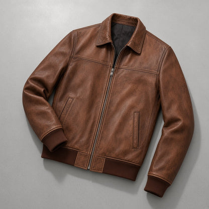 Men's Vintage Distressed Brown Leather Bomber Jacket, flat lay on grey concrete